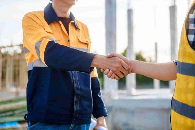 Gateway Tree Experts representative shaking hands with a satisfied homeowner after completing professional emergency tree service in St. Louis, MO.